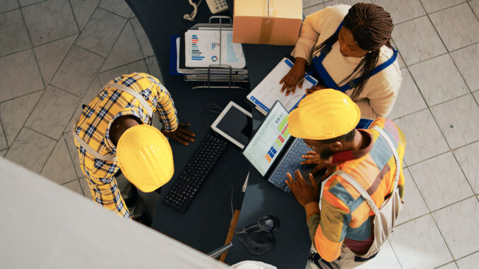 African american people looking at supplies list on pc